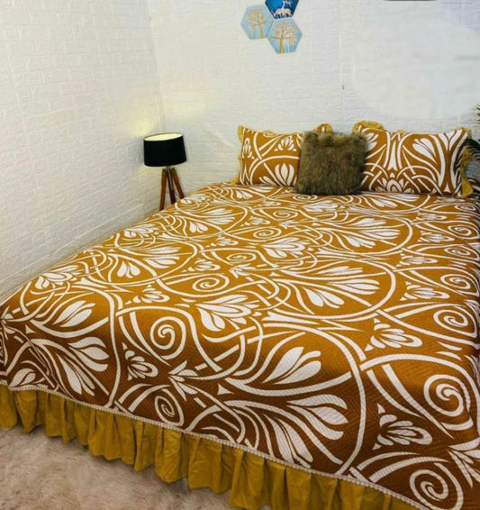 Rich Gold Printed Quilted Bedcover With Frill On The Three Bedside